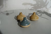 three Cara Guthrie bud vases sitting on a table. 