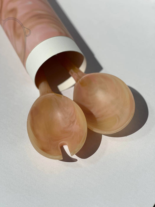Two beige silicone cups with a white cylindrical container on a light gray background. Maegen | Shop Fodder