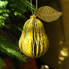 Decorative ornament hanging on a Christmas tree with a blurred background | East End Press | Shop Fodder