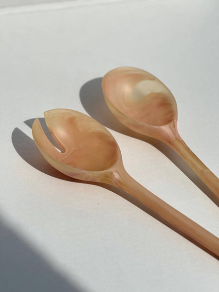 Two wooden spoons on a light surface with a soft shadow. Maegen | Shop Fodder