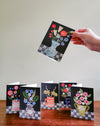Hand holding a floral card with other cards on a wooden surface and light gray background. Make your own thank you cards | Hadley Paper Goods | Fodder